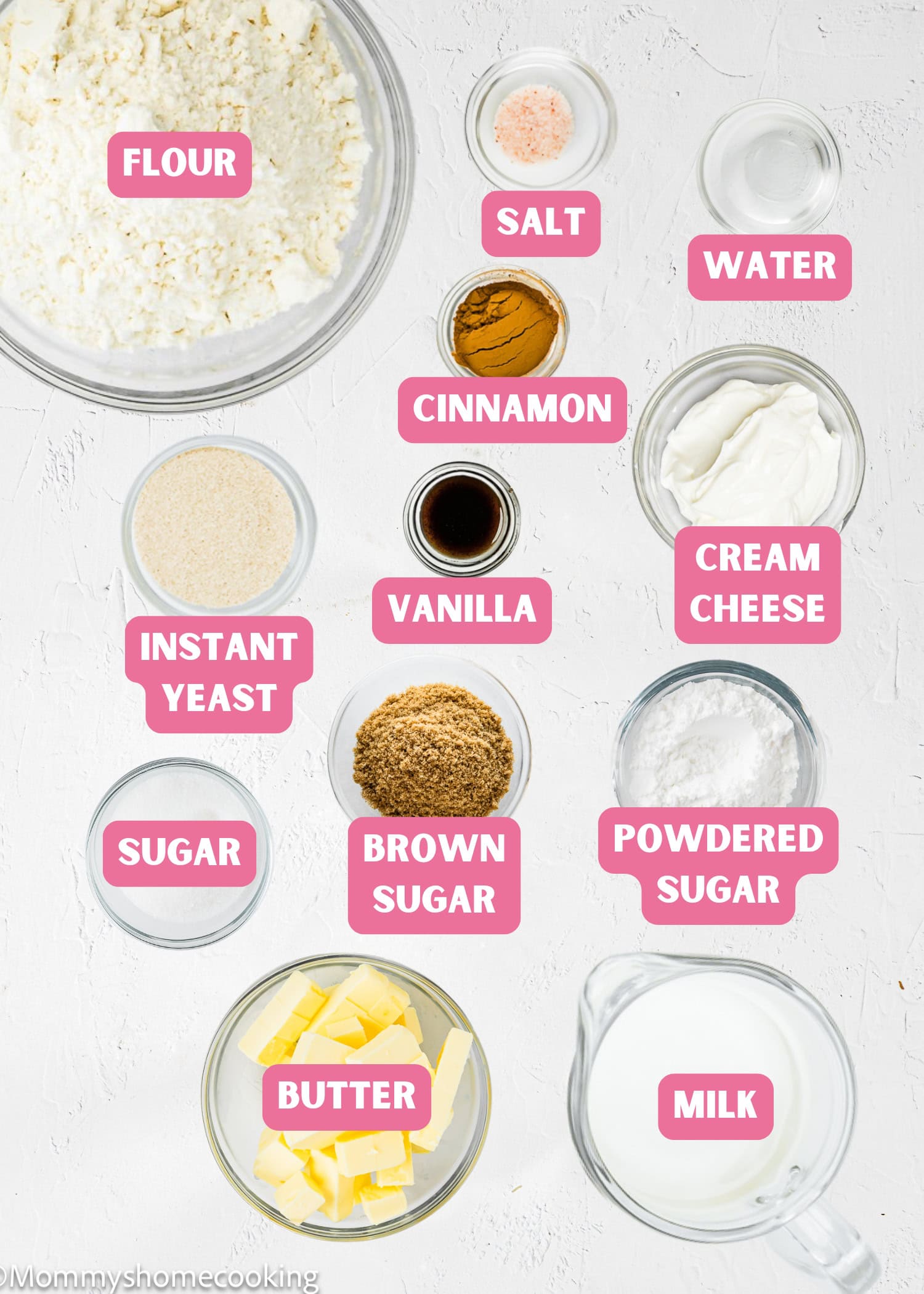 Bowls and cups contain labeled ingredients for Overnight Cinnamon Rolls (Small Batch): flour, salt, water, cinnamon, cream cheese, vanilla, instant yeast, sugar, brown sugar, powdered sugar, butter, and milk.