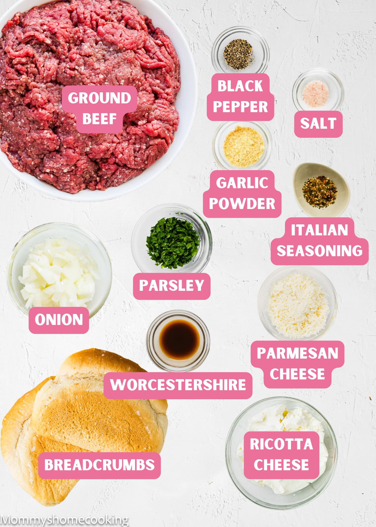 Ingredients for a Simple Meatball Recipe Without Eggs arranged on a white surface: ground beef, black pepper, salt, garlic powder, Italian seasoning, onion, parsley, Parmesan cheese, Worcestershire sauce, breadcrumbs, and ricotta cheese.