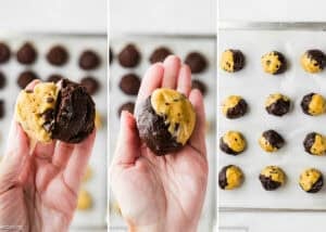 A hand holding and assembling Eggless Brookie Cookies (One Dough) dough balls, with mixed chocolate chip and chocolate cookie dough balls arranged on a baking sheet.