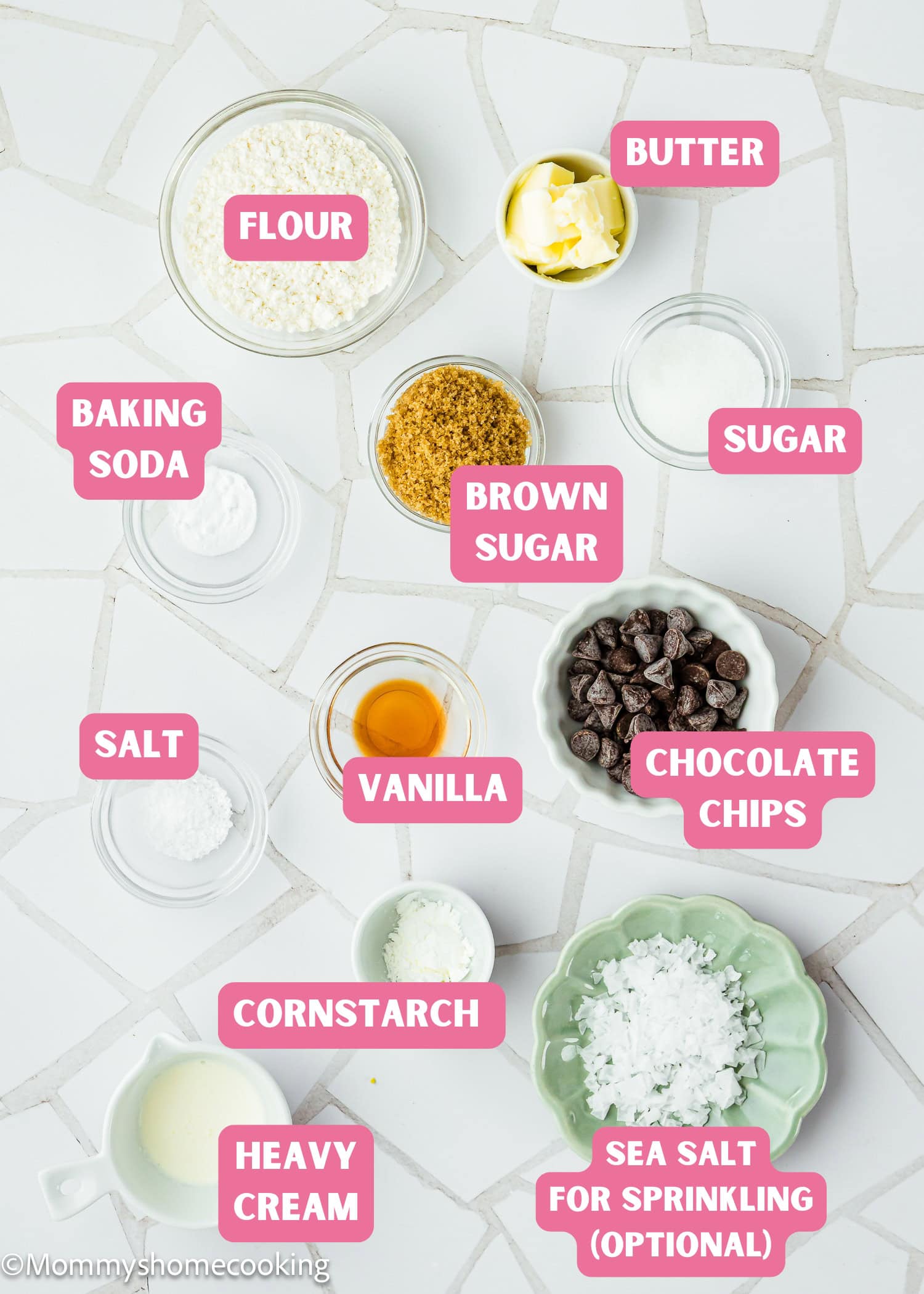 Overhead view of labeled baking ingredients for a Single Serve Chocolate Chip Cookie No Egg, including flour, butter, sugar, brown sugar, chocolate chips, vanilla, baking soda, cornstarch, salt, and sea salt.
