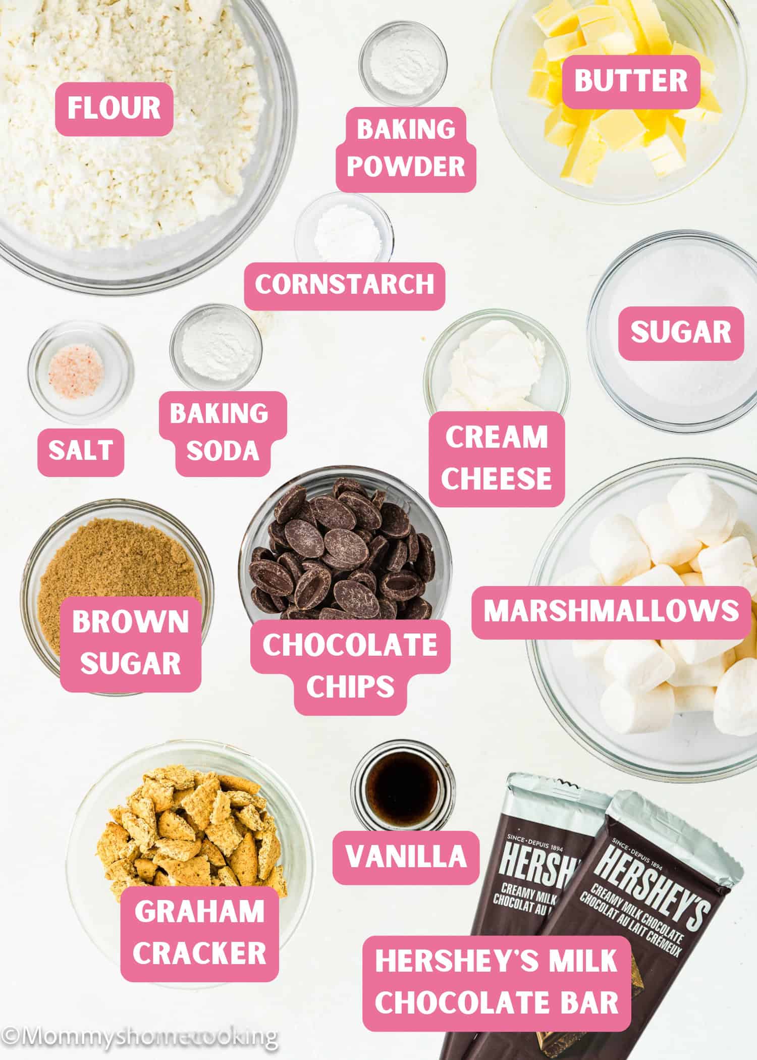 Various baking ingredients in bowls and plates are labeled, including flour, butter, cream cheese, sugar, brown sugar, chocolate chips, marshmallows, graham crackers, and Hershey’s chocolate bars—perfect for making Egg-Free S’mores Cookies.