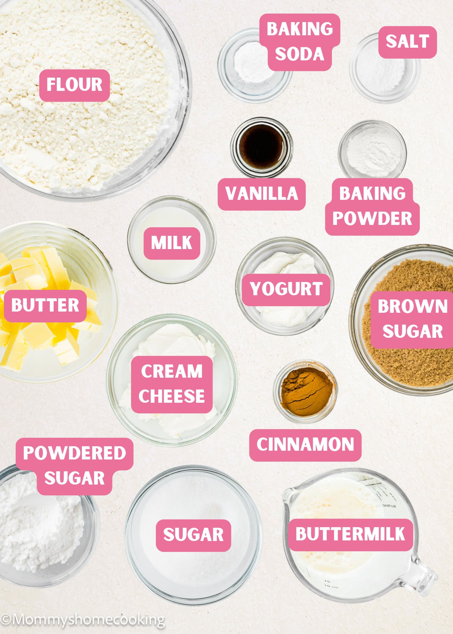 Top view of labeled baking ingredients in bowls and containers for Eggless Cream Cheese Coffee Cake, including flour, baking soda, salt, vanilla, milk, yogurt, brown sugar, butter, cream cheese, cinnamon, powdered sugar, sugar, and buttermilk.