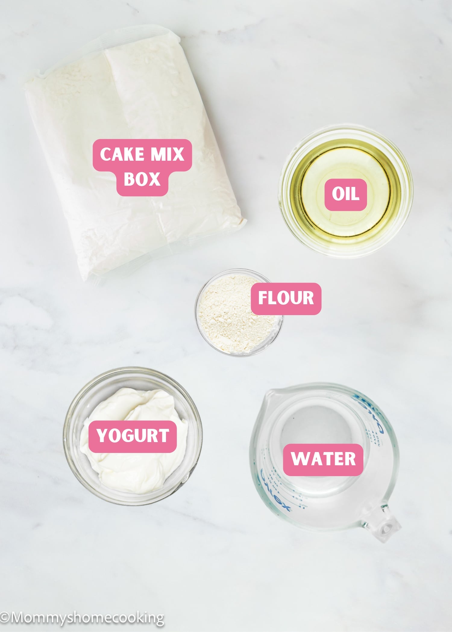 Five labeled ingredients on a countertop show How to Make Box Cake Mix Without Eggs: cake mix box, oil in a bowl, flour in a cup, yogurt in a bowl, and water in a measuring cup.