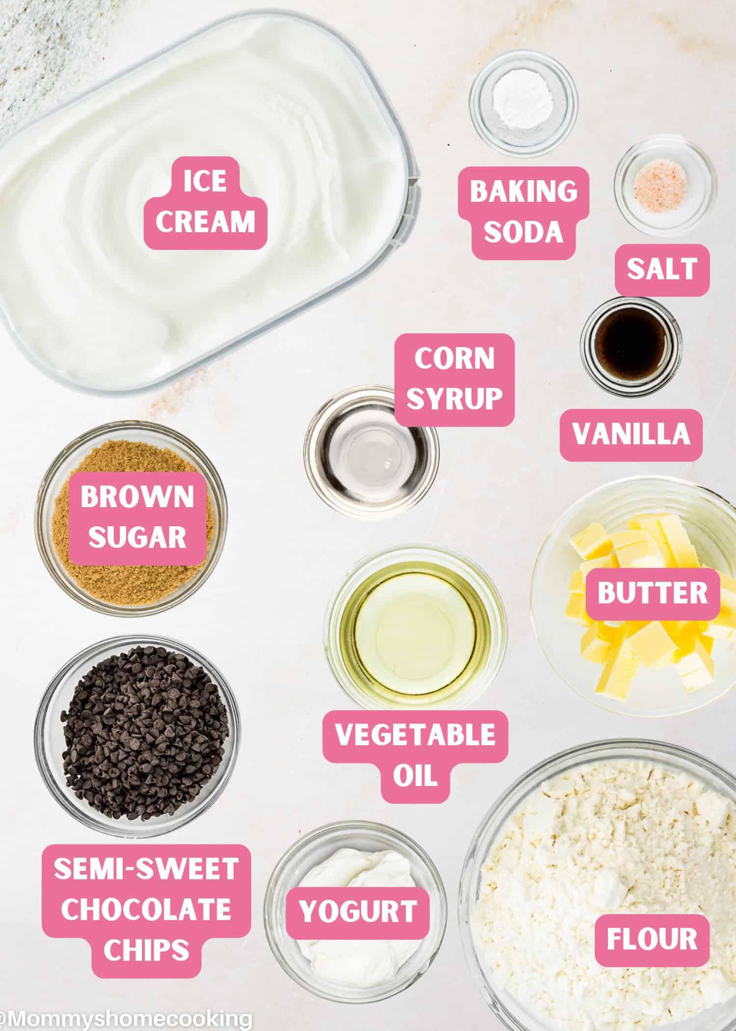 Top-down view of labeled baking ingredients, including ice cream, baking soda, salt, vanilla, butter, flour, yogurt, vegetable oil, semi-sweet chocolate chips, corn syrup, and brown sugar—perfect for Eggless Chocolate Chip Cookie Ice Cream Cake.