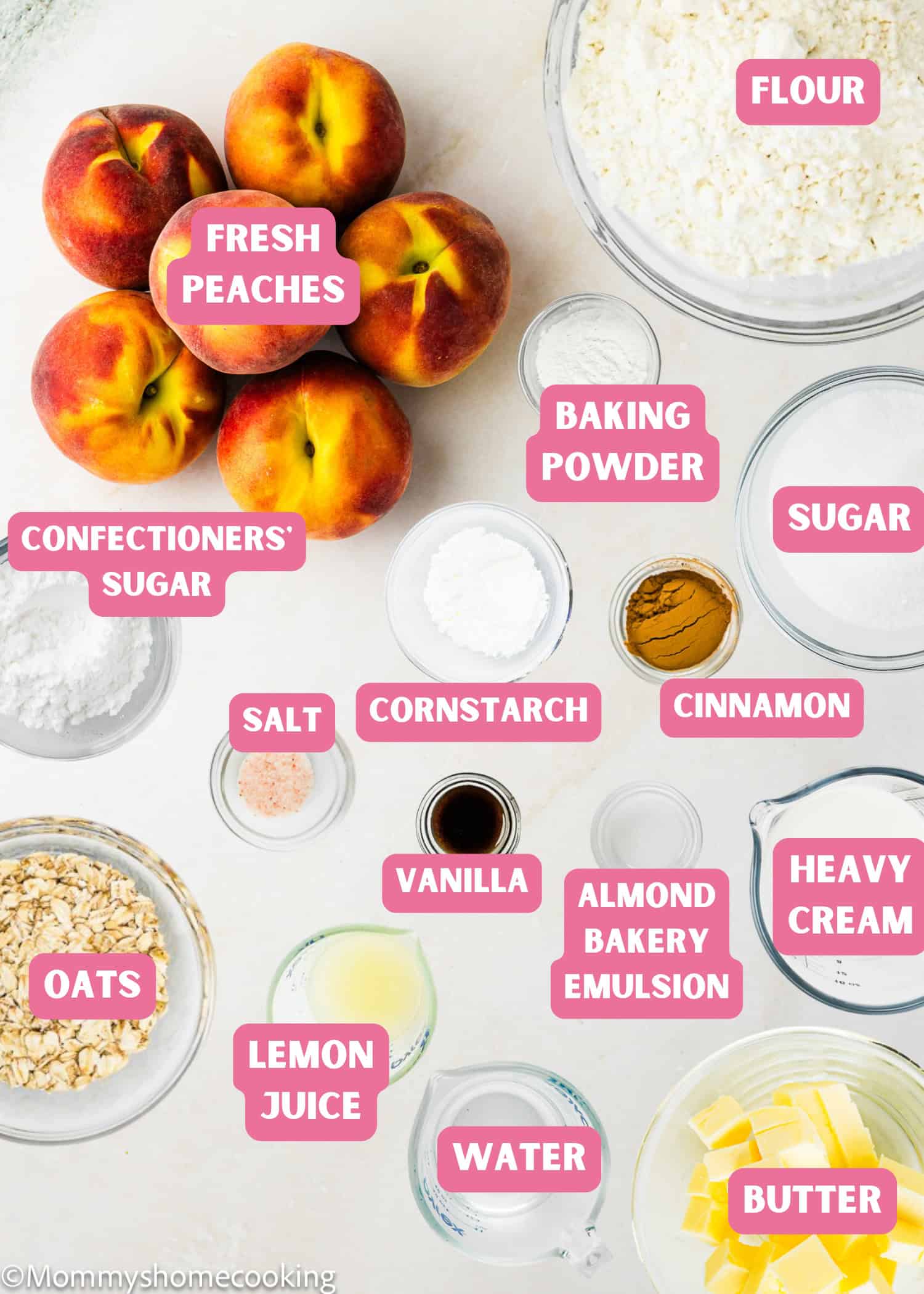 Top-down view of labeled baking ingredients for Eggless Peach Crumb Bars, including fresh peaches, flour, sugar, oats, baking powder, cornstarch, vanilla, butter, heavy cream, lemon juice, and spices.